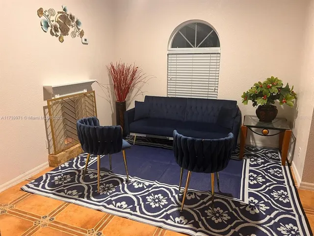 a living room with a couch and a potted plant