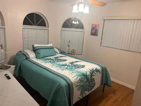 a bedroom with two beds and a window