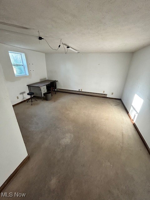 17510 Munn Road Chagrin Falls, OH 44023 - Photo 31 of 35 Spare room featuring a baseboard radiator, baseboards, and a textured ceiling