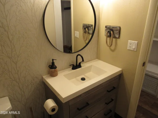 a bathroom with a sink and mirror