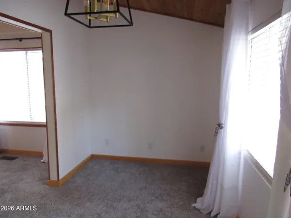 a view of small space with wooden floor and windows