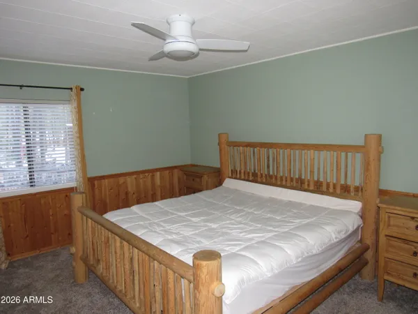 a bed sitting in a bedroom next to a window