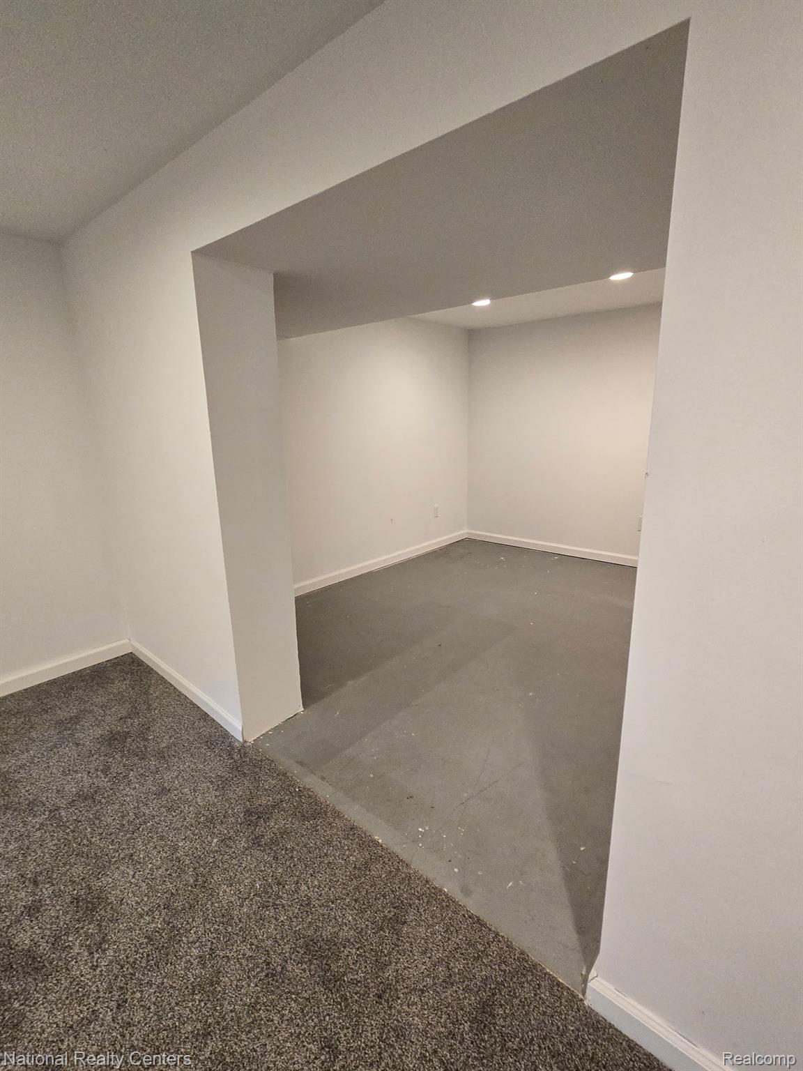 616 Rickett Road, Unit 130 Brighton, MI 48116 - Photo 16 of 20 Recessed lighting illuminates a space with painted concrete flooring