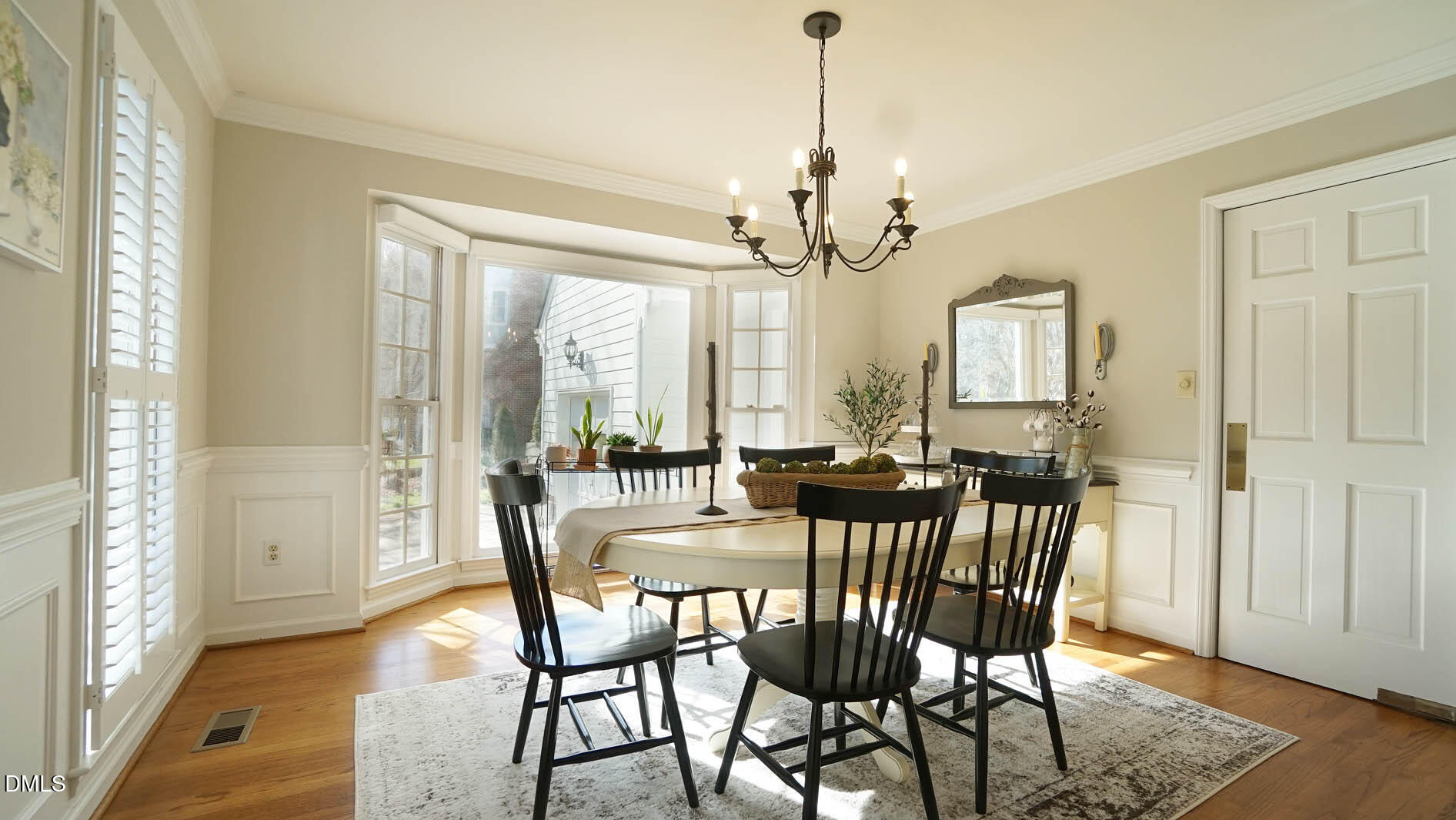 8613 Windjammer Drive Raleigh, NC 27615 - Photo 10 of 52 a view of a dining room with furniture window and wooden floor