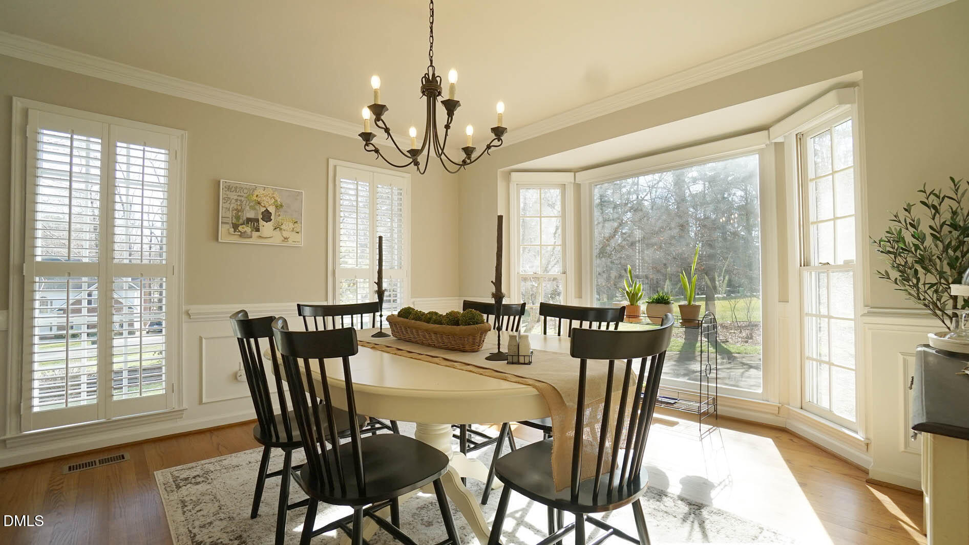 8613 Windjammer Drive Raleigh, NC 27615 - Photo 11 of 52 a view of a dining room with furniture window and wooden floor