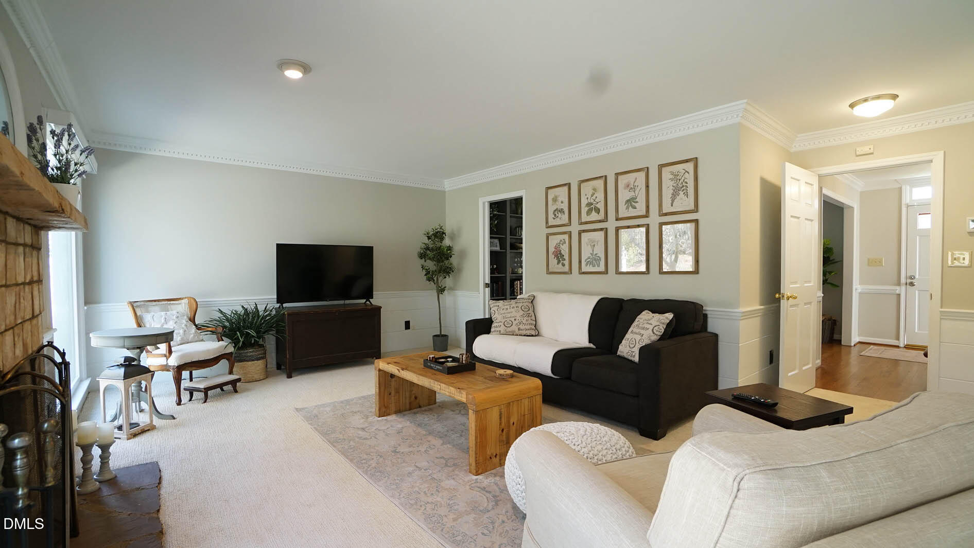 8613 Windjammer Drive Raleigh, NC 27615 - Photo 14 of 52 a living room with furniture and a flat screen tv