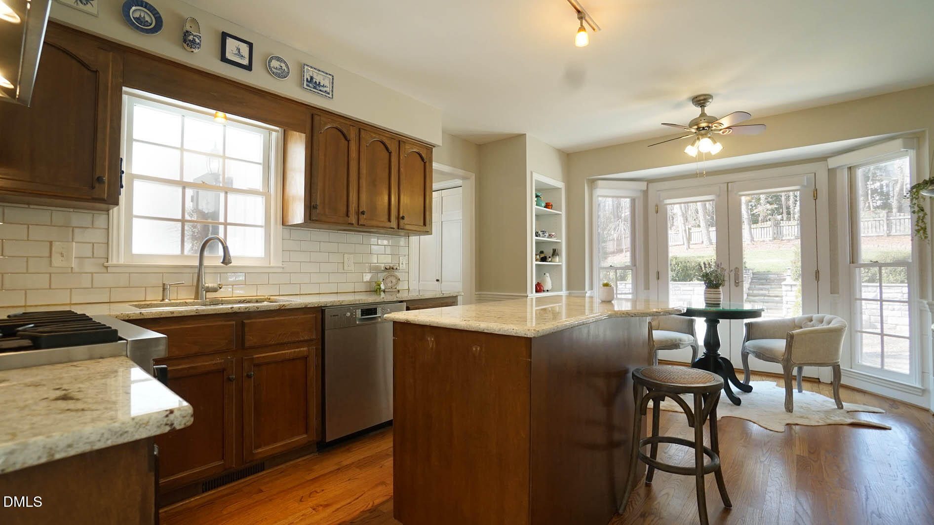8613 Windjammer Drive Raleigh, NC 27615 - Photo 15 of 52 a kitchen with granite countertop a sink stove and cabinets