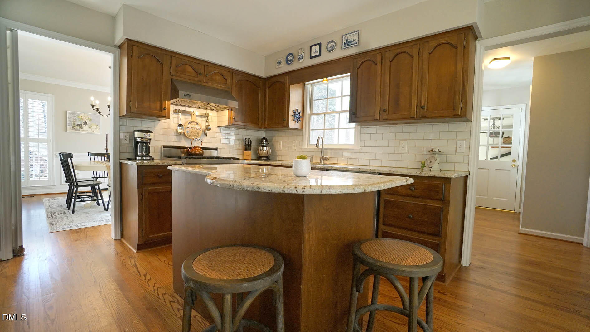 8613 Windjammer Drive Raleigh, NC 27615 - Photo 16 of 52 a kitchen with a sink cabinets and wooden floor