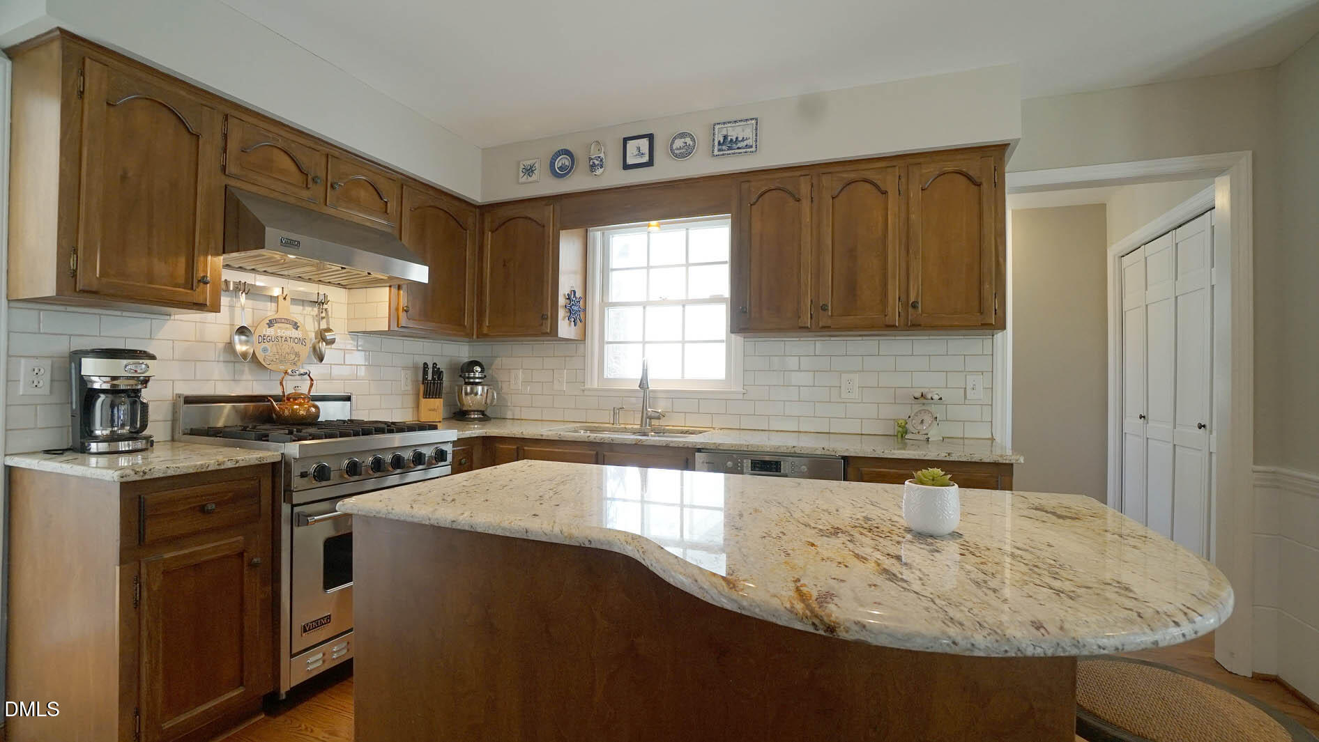 8613 Windjammer Drive Raleigh, NC 27615 - Photo 19 of 52 a kitchen with granite countertop a sink stainless steel appliances and cabinets