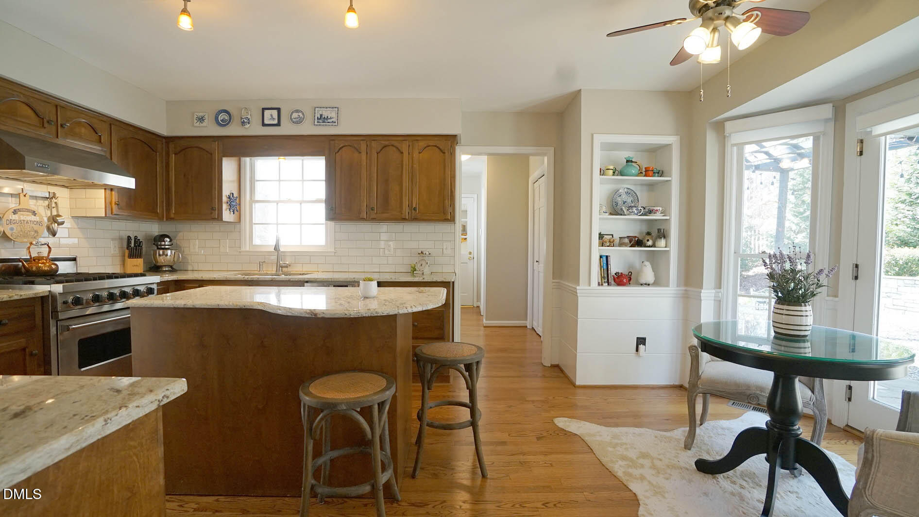 8613 Windjammer Drive Raleigh, NC 27615 - Photo 20 of 52 a kitchen with a table chairs a sink dishwasher window and cabinets