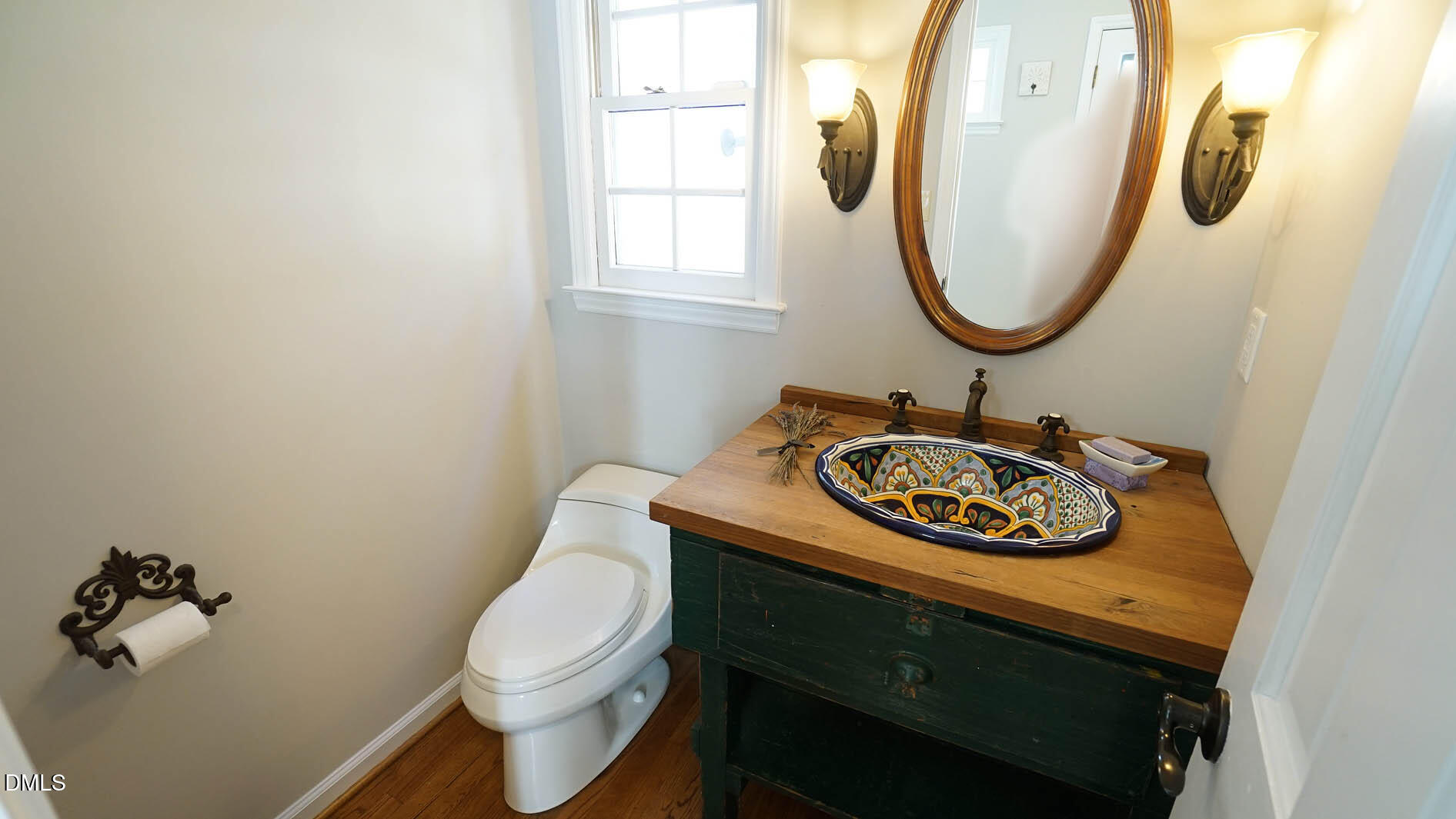 8613 Windjammer Drive Raleigh, NC 27615 - Photo 22 of 52 a bathroom with a sink a mirror and a toilet