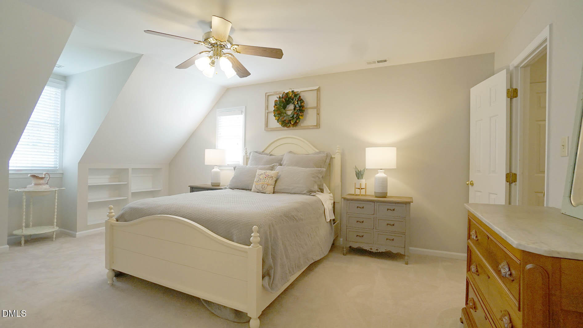 8613 Windjammer Drive Raleigh, NC 27615 - Photo 23 of 52 a bedroom with a bed and a chandelier