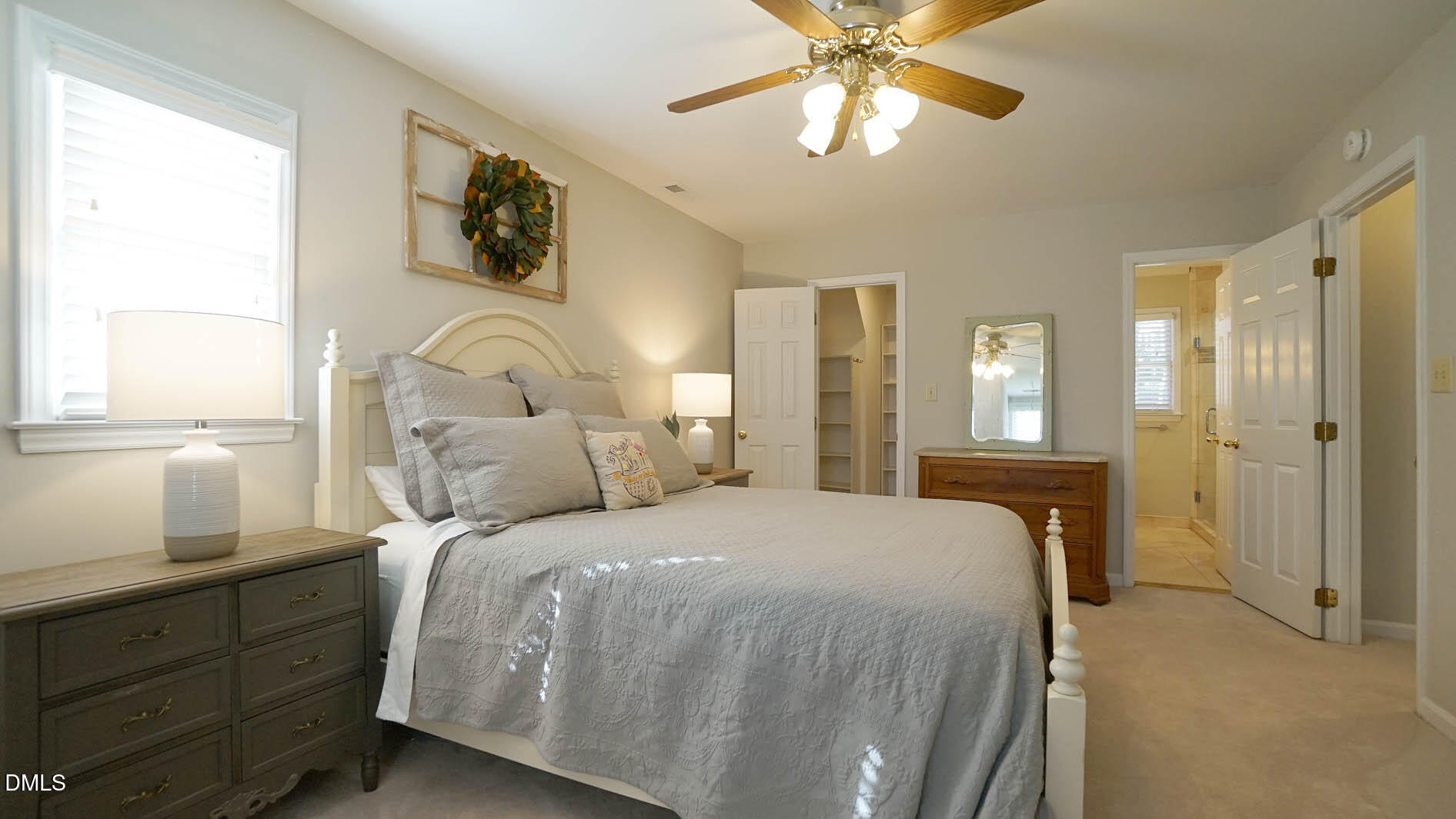 8613 Windjammer Drive Raleigh, NC 27615 - Photo 24 of 52 a bedroom with a large bed and a chandelier