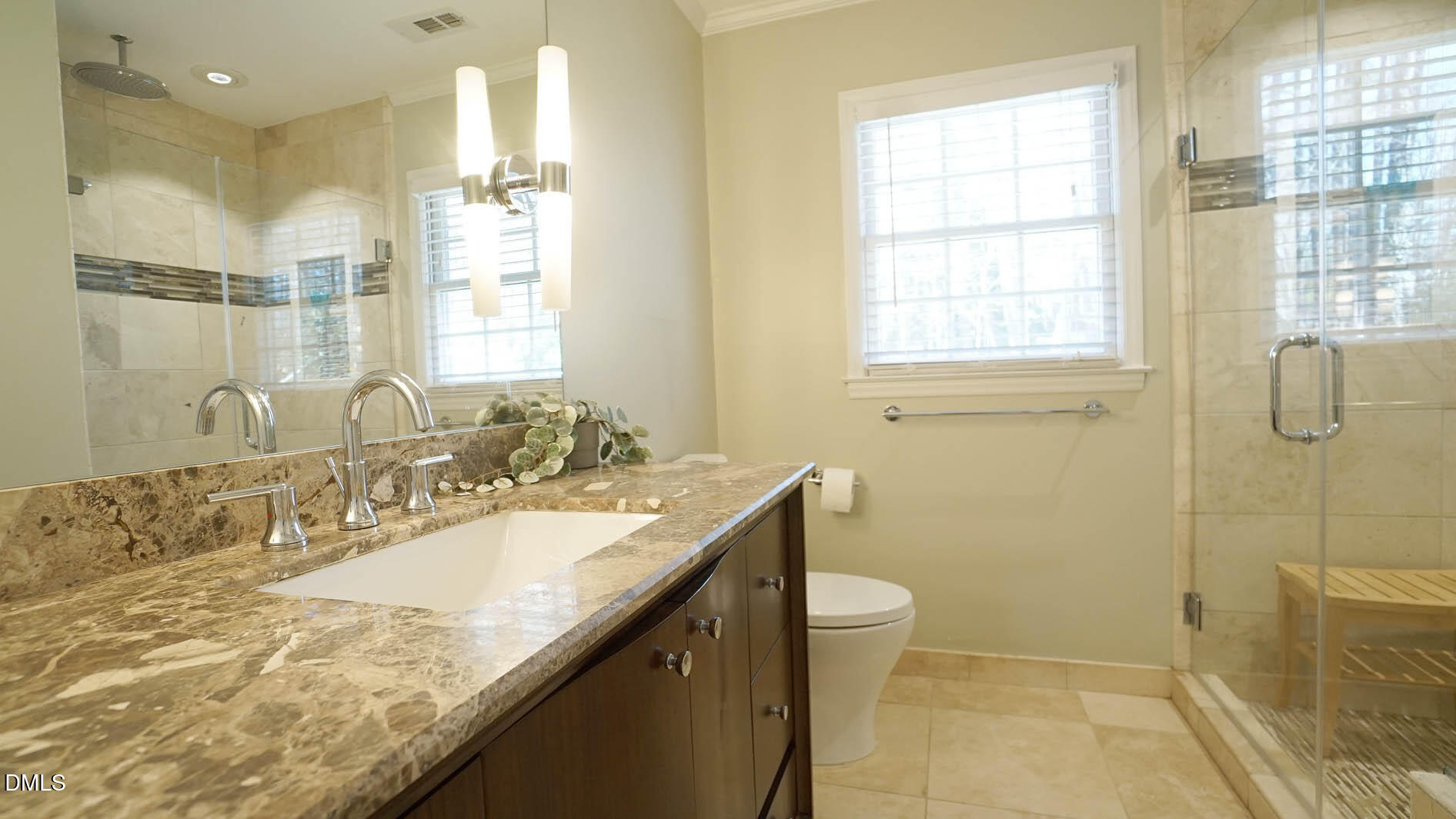 8613 Windjammer Drive Raleigh, NC 27615 - Photo 26 of 52 a bathroom with a granite countertop sink a toilet and shower
