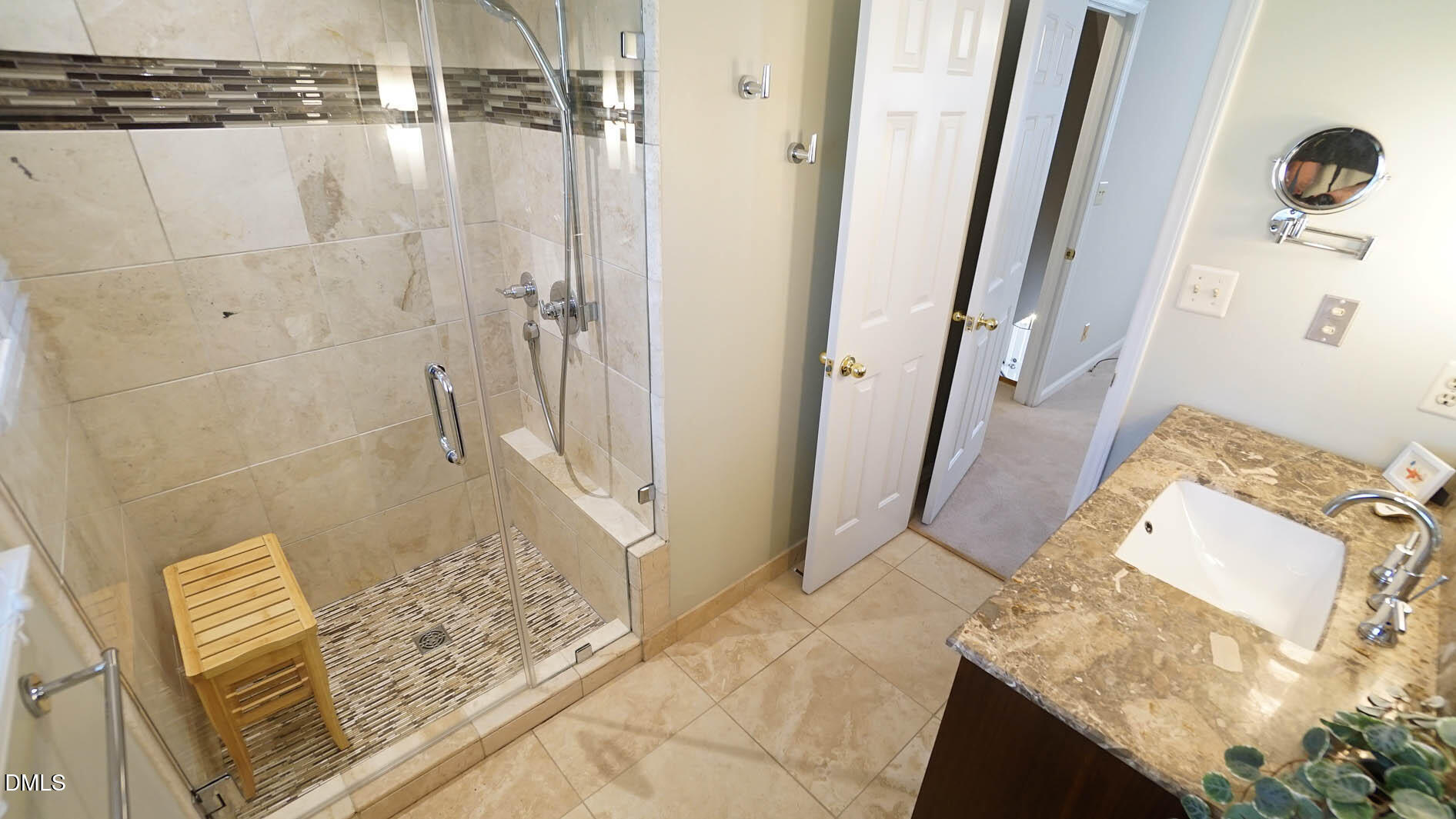 8613 Windjammer Drive Raleigh, NC 27615 - Photo 27 of 52 a bathroom with a granite countertop shower and a sink