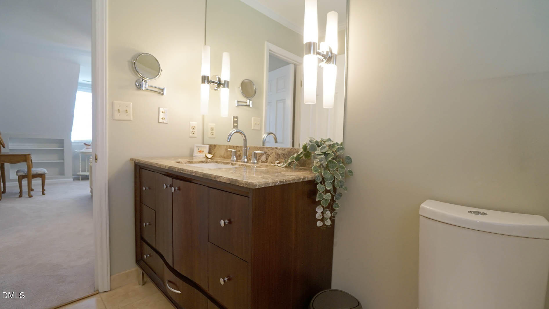 8613 Windjammer Drive Raleigh, NC 27615 - Photo 28 of 52 a bathroom with a sink vanity mirror and toilet