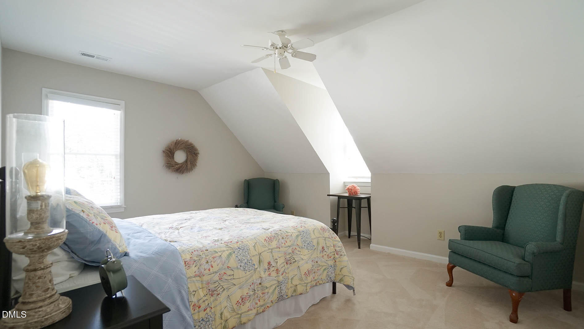 8613 Windjammer Drive Raleigh, NC 27615 - Photo 33 of 52 a bedroom with a bed a couch and a dresser with wooden floor