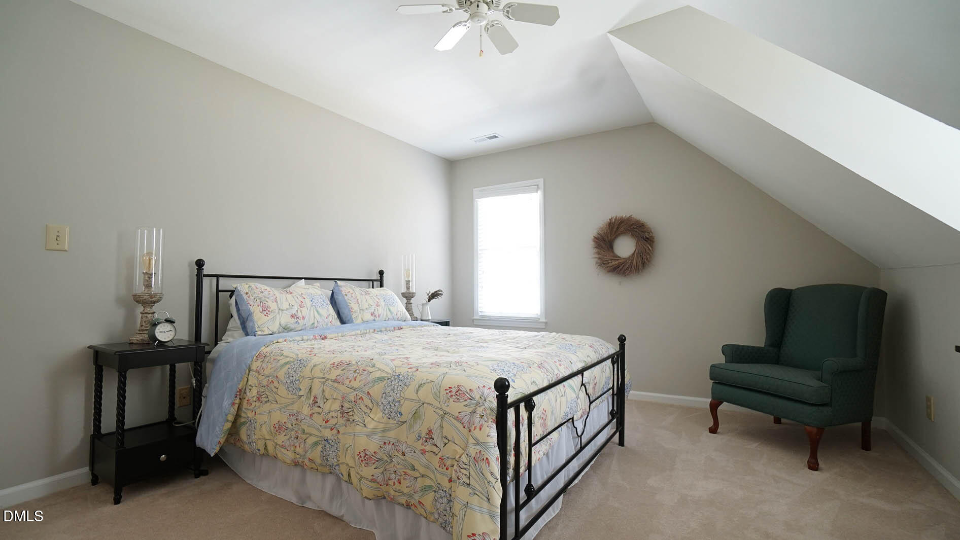 8613 Windjammer Drive Raleigh, NC 27615 - Photo 34 of 52 a bedroom with a bed and a chandelier