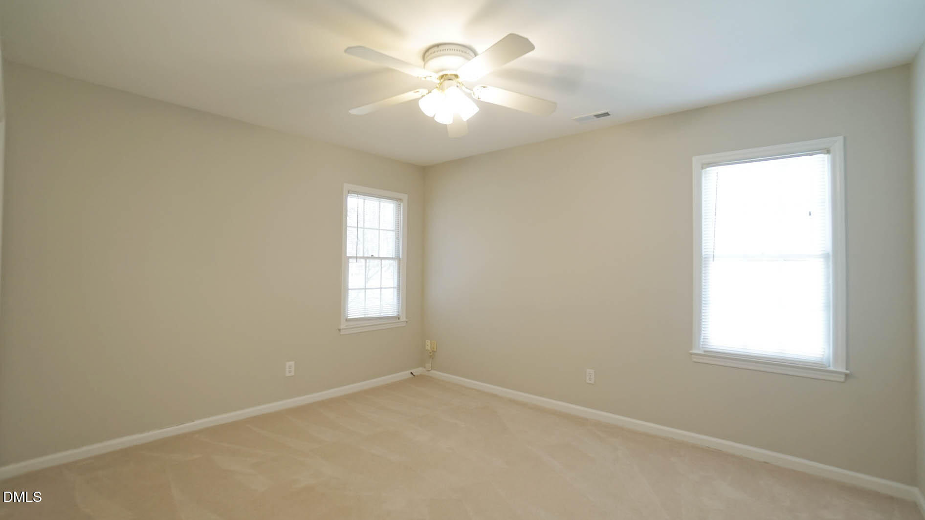 8613 Windjammer Drive Raleigh, NC 27615 - Photo 35 of 52 an empty room with windows and fan