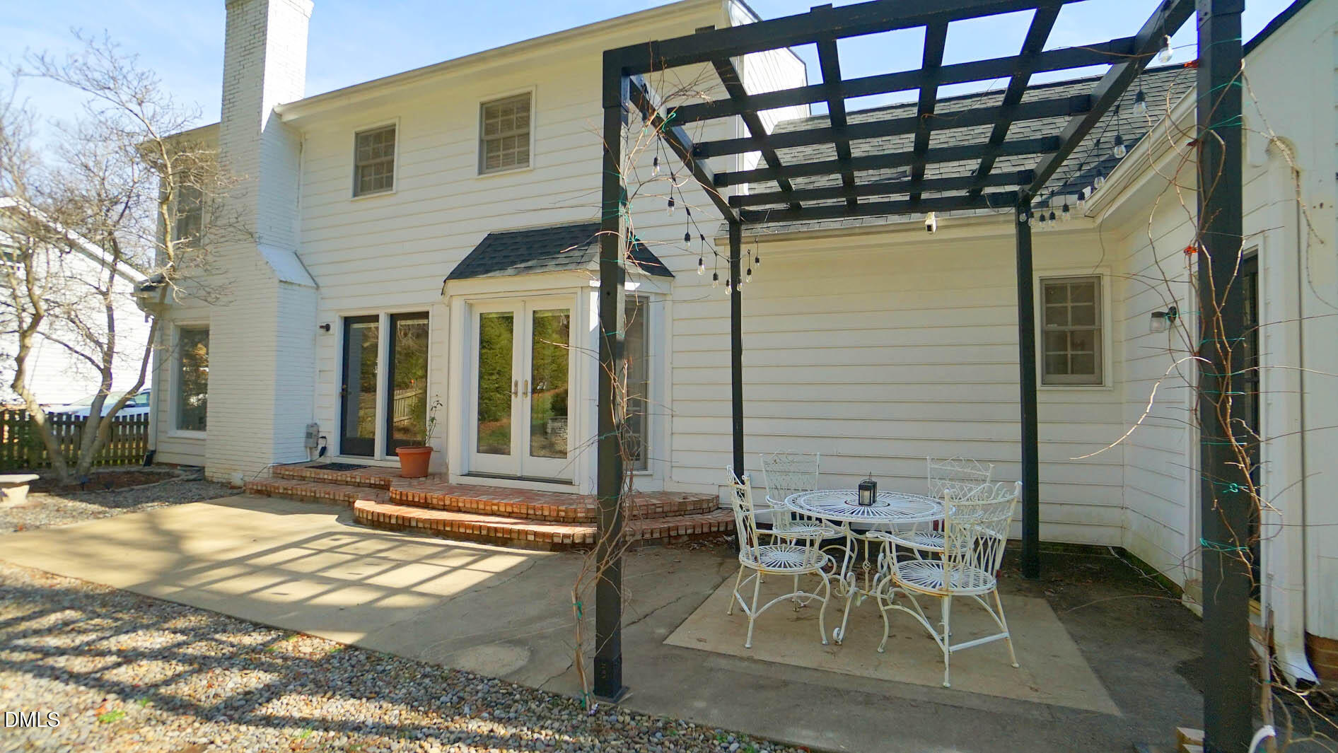 8613 Windjammer Drive Raleigh, NC 27615 - Photo 42 of 52 a patio with table and chairs and potted plants