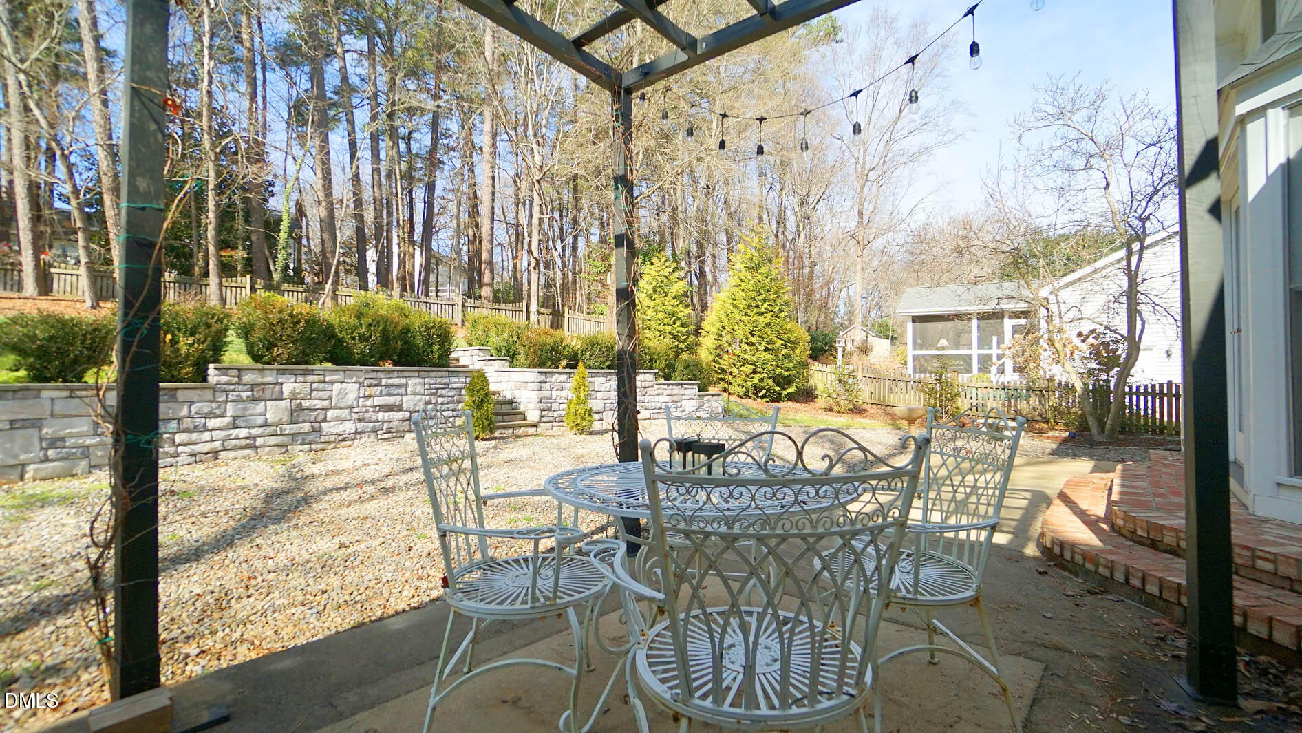 8613 Windjammer Drive Raleigh, NC 27615 - Photo 44 of 52 a patio with glass top table and chairs