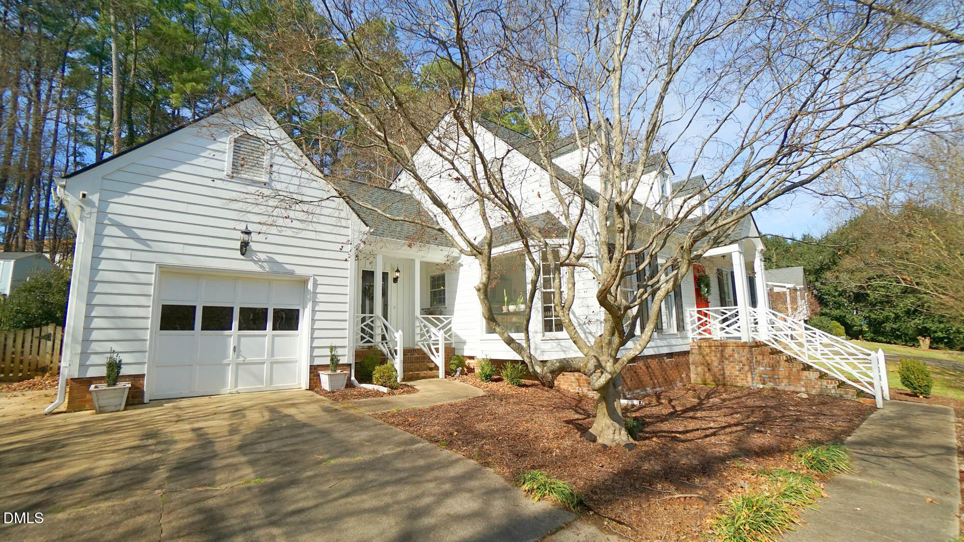 8613 Windjammer Drive Raleigh, NC 27615 - Photo 46 of 52 a front view of a house with a yard and garage