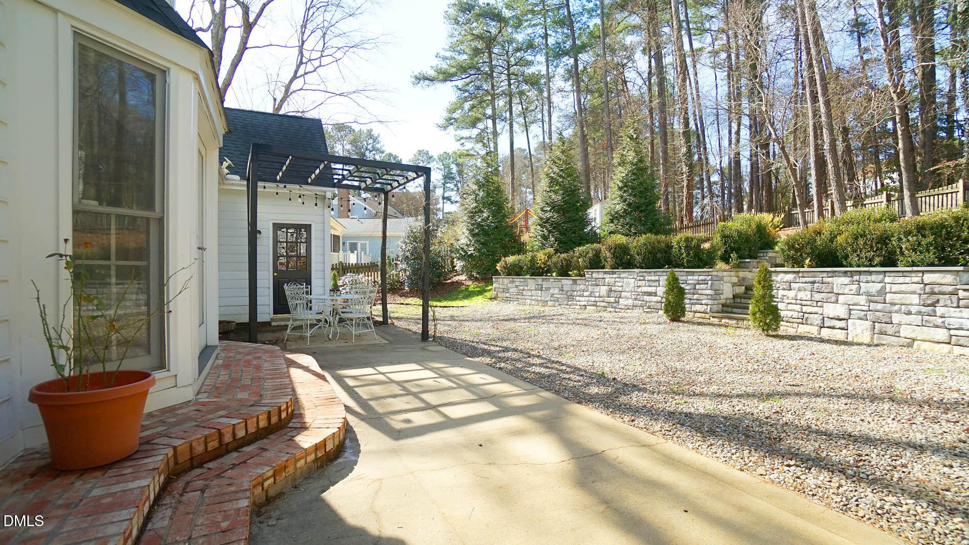 8613 Windjammer Drive Raleigh, NC 27615 - Photo 6 of 52 a backyard of a house with fountain table and chairs