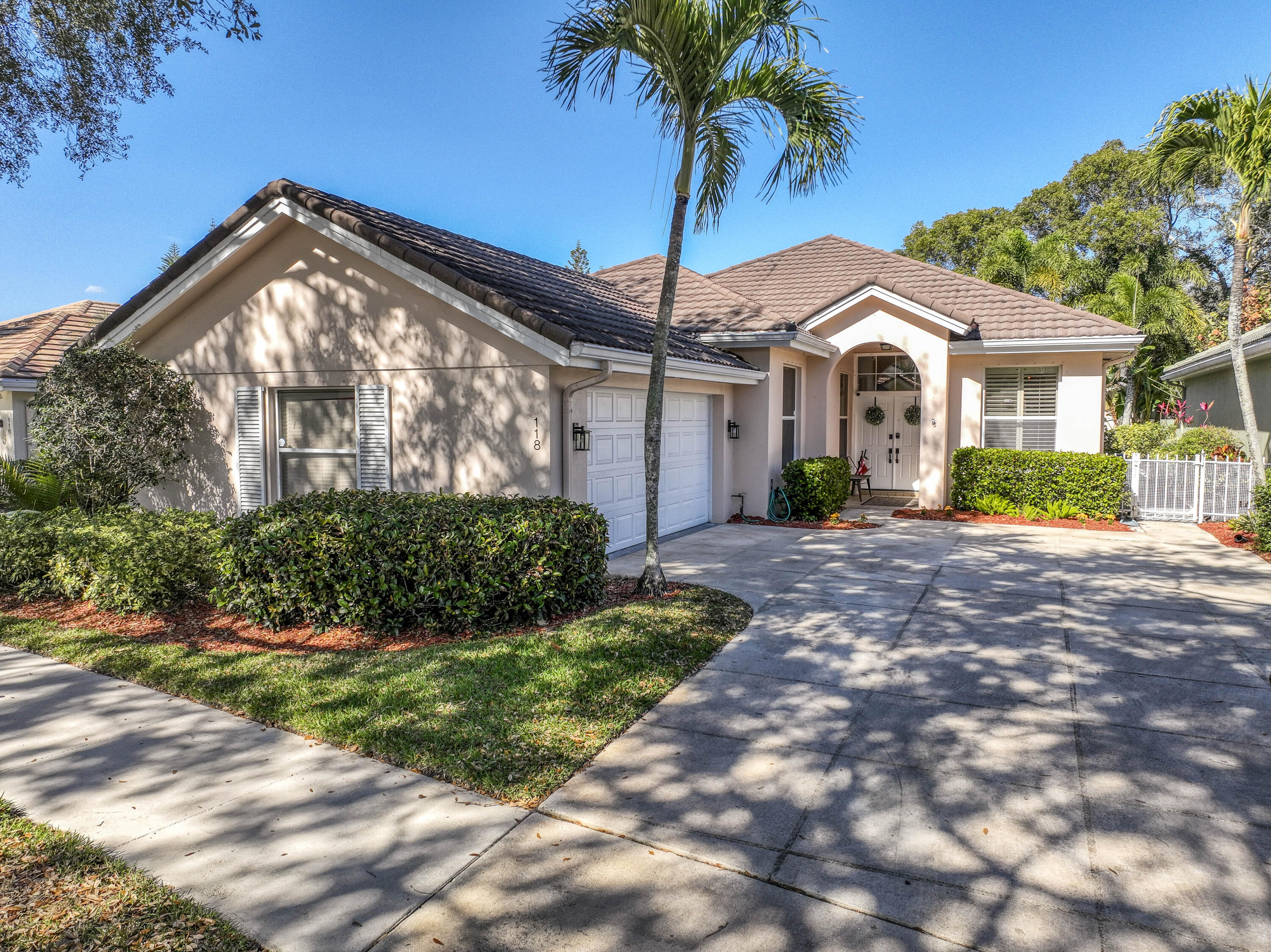 118 East Hampton Way Jupiter, FL 33458 - Photo 1 of 42 a front view of a house with a garden