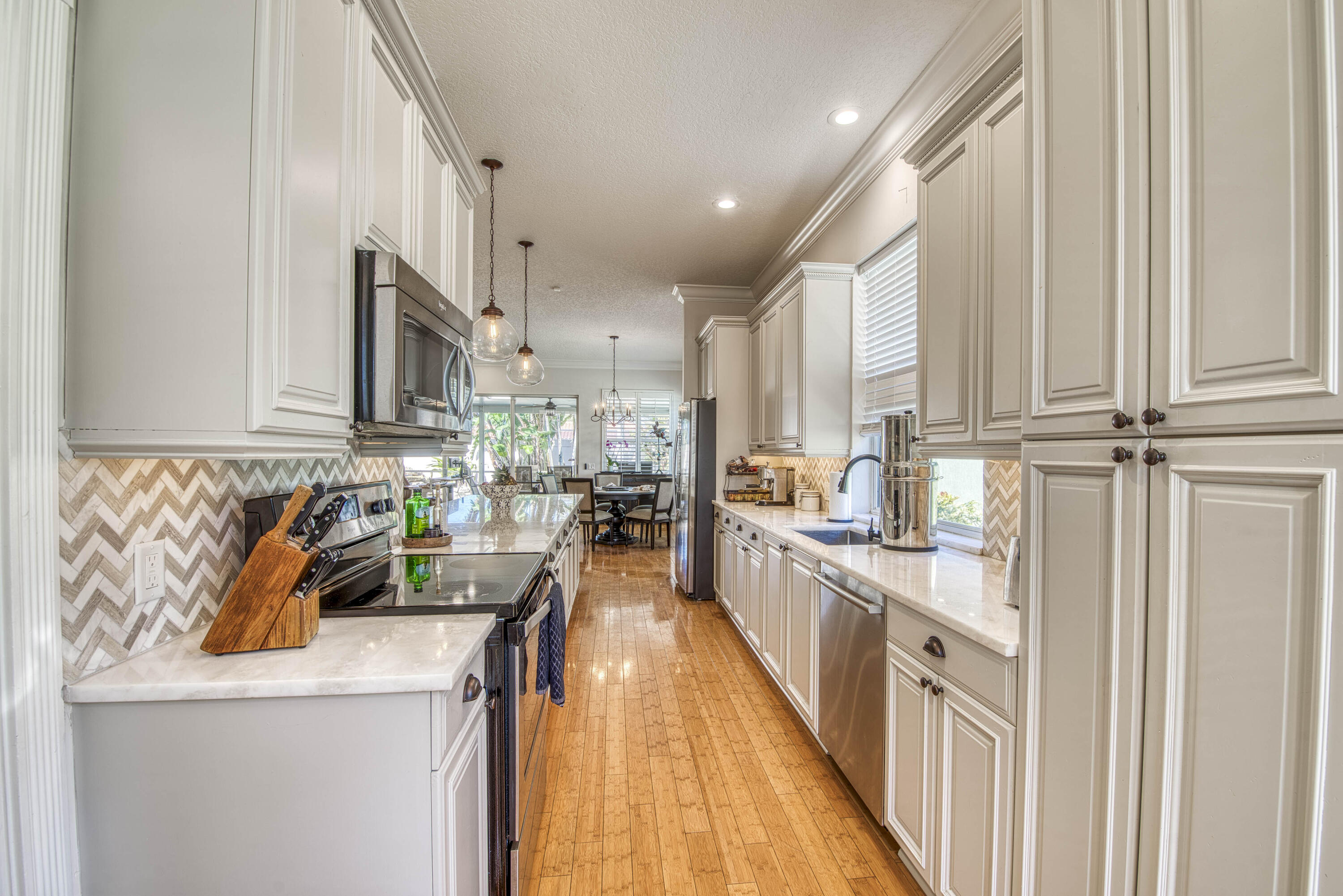 118 East Hampton Way Jupiter, FL 33458 - Photo 14 of 42 a kitchen with kitchen island granite countertop a sink a counter top space stainless steel appliances and cabinets