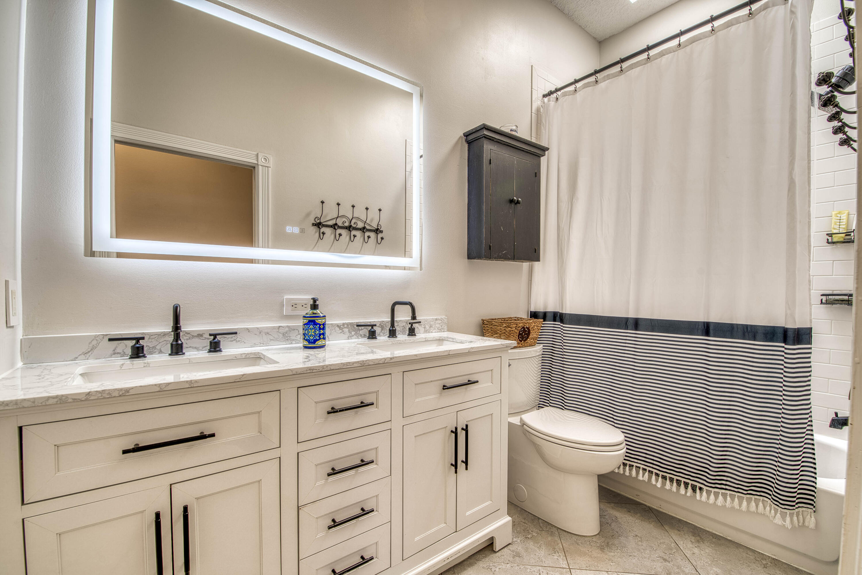 118 East Hampton Way Jupiter, FL 33458 - Photo 28 of 42 a bathroom with a toilet sink a mirror and vanity
