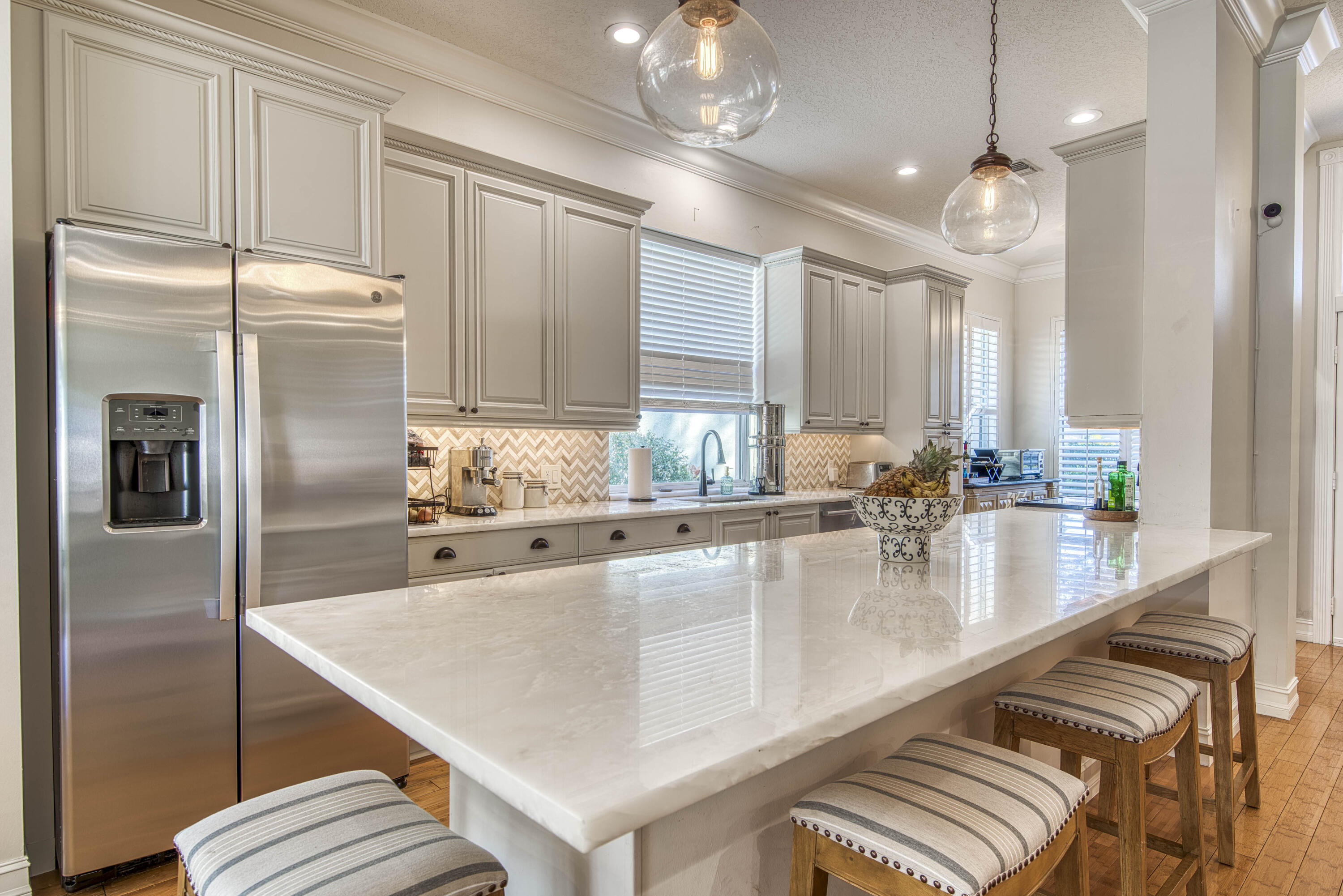 118 East Hampton Way Jupiter, FL 33458 - Photo 5 of 42 a kitchen with kitchen island a counter and a refrigerator
