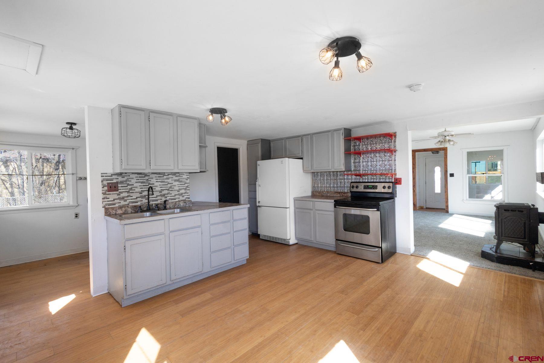 690 Grape Street Nucla, CO 81424 - Photo 13 of 24 a kitchen with stainless steel appliances kitchen island granite countertop a stove a sink and a refrigerator