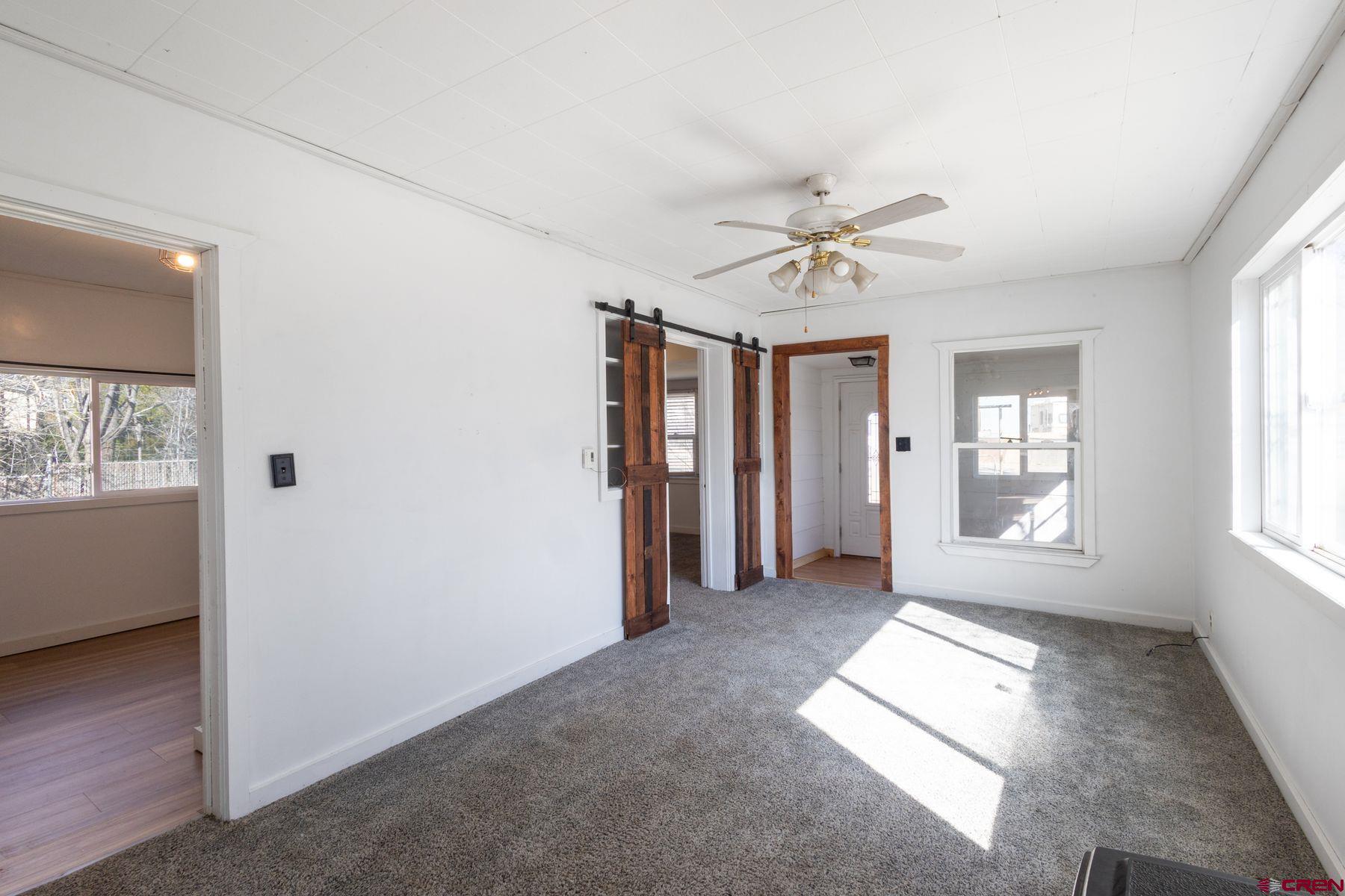 690 Grape Street Nucla, CO 81424 - Photo 14 of 24 a view of livingroom with window ceiling fan and hardwood floor