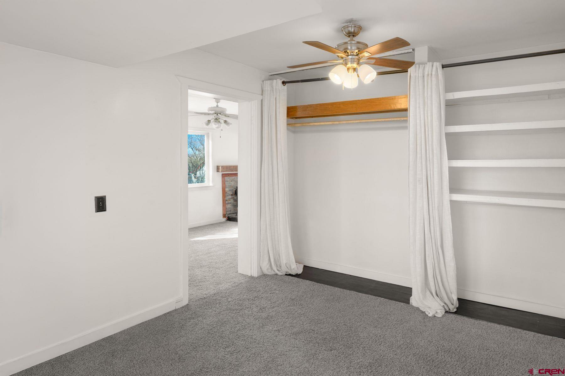 690 Grape Street Nucla, CO 81424 - Photo 18 of 24 an empty room with closet and a ceiling fan