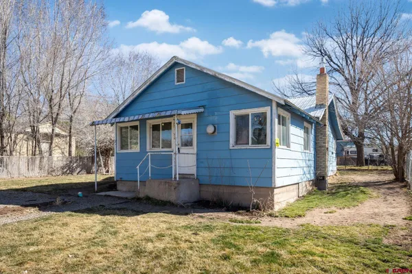 a view of a house with a yard covered with snow