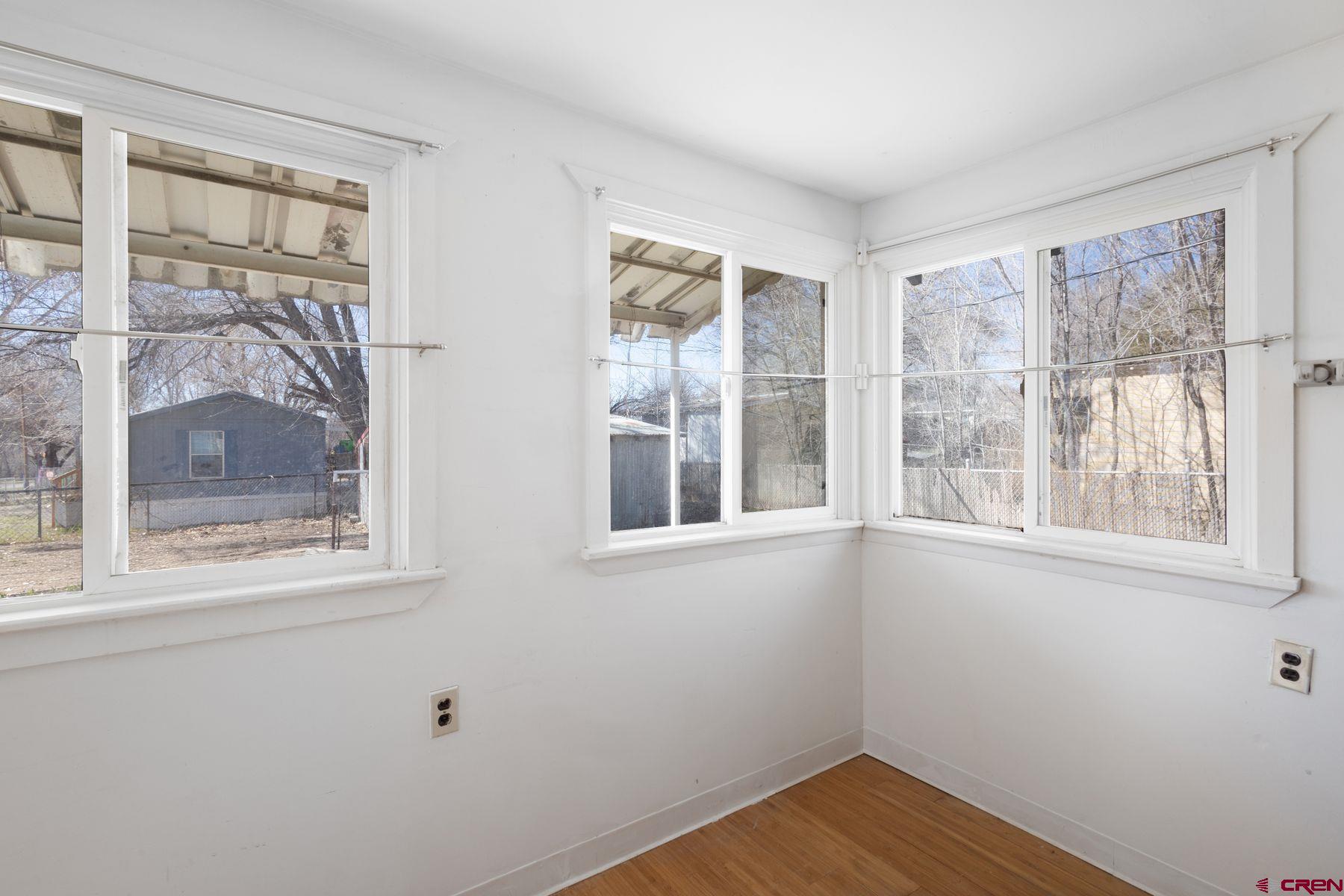 690 Grape Street Nucla, CO 81424 - Photo 8 of 24 a view of empty room with wooden floor and fan