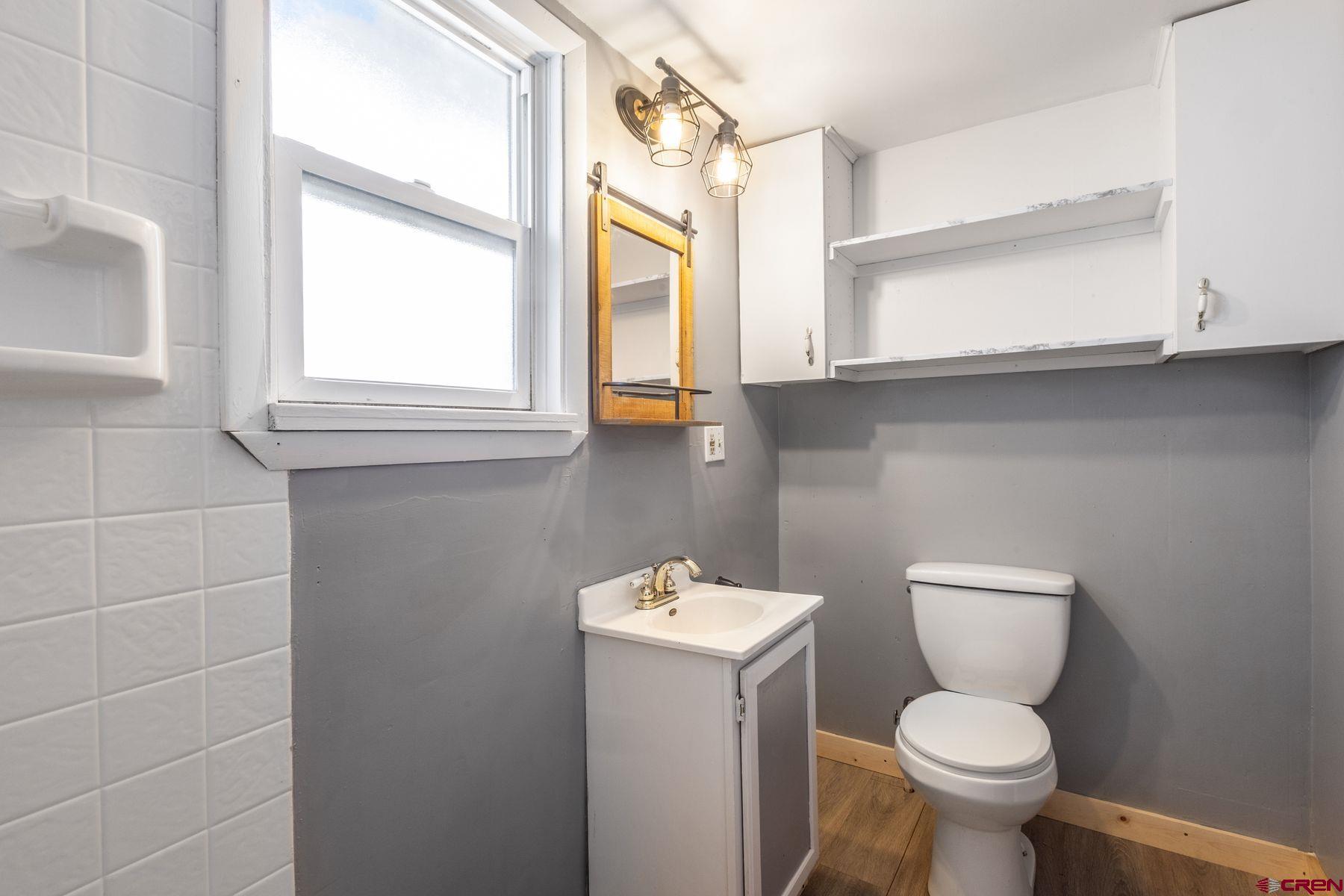 690 Grape Street Nucla, CO 81424 - Photo 10 of 24 a bathroom with a toilet sink and a window