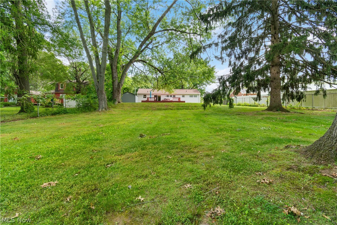 5768 Nolley Road Akron, OH 44319 - Photo 30 of 38 Expansive green lawn with mature trees and a distant dwelling