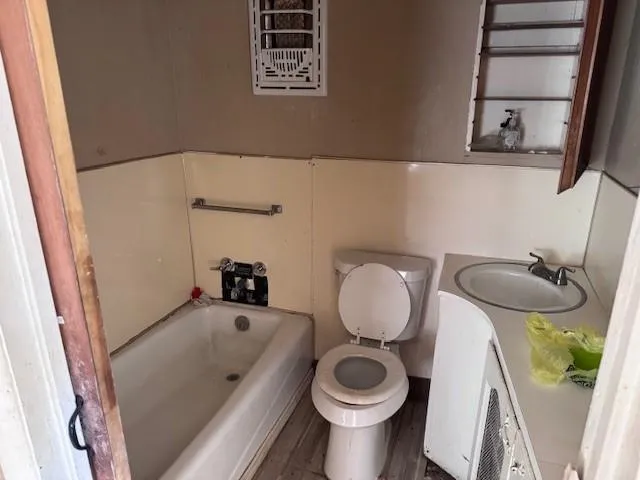a bathroom with a toilet and a sink