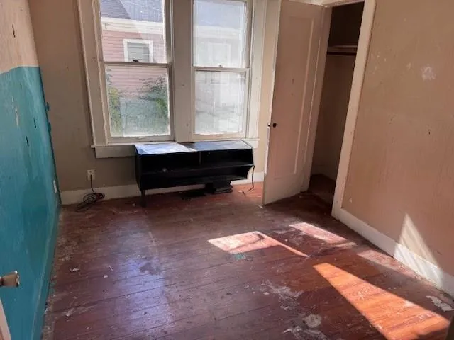 a room with window and a rug