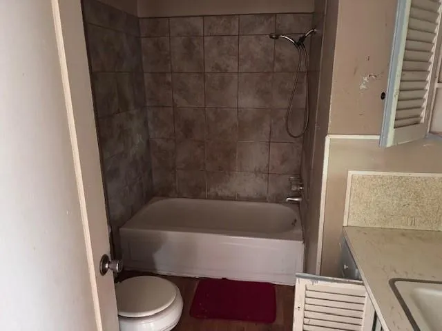 a bathroom with a bathtub and a toilet