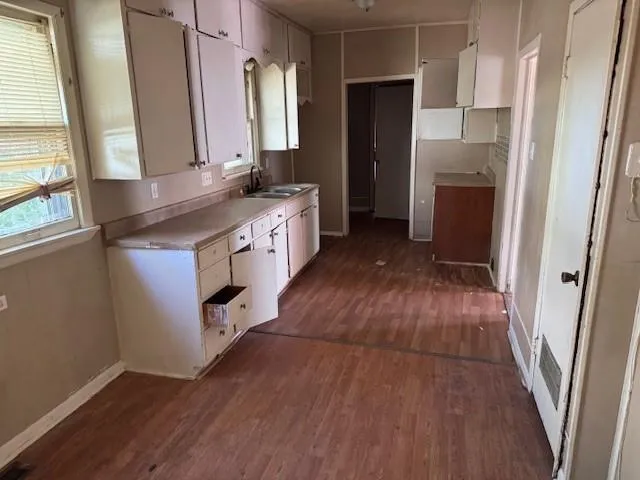 a kitchen with stainless steel appliances granite countertop a refrigerator a sink and a stove