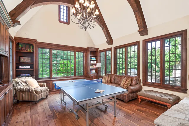 a living room with furniture and large windows
