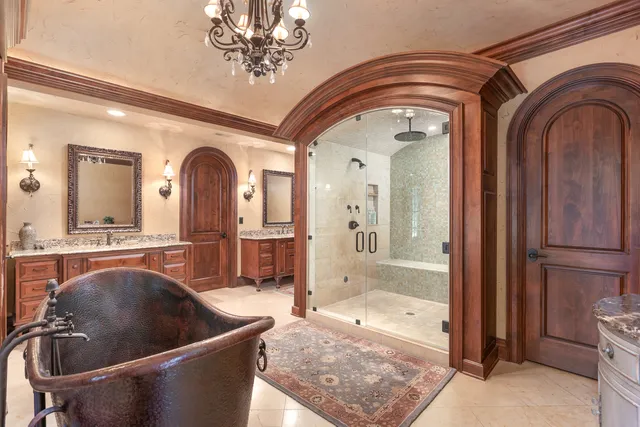 a living room with fireplace furniture and a chandelier