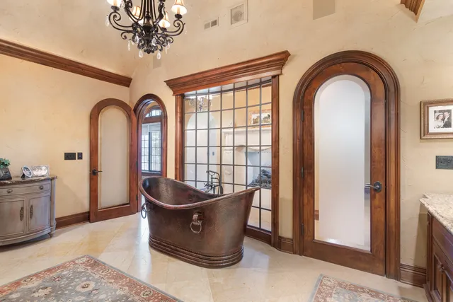 a room with a bed and a chandelier