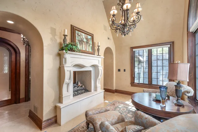 a kitchen with granite countertop a sink white cabinets and stainless steel appliances