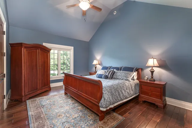 a bedroom with a large bed and a chandelier
