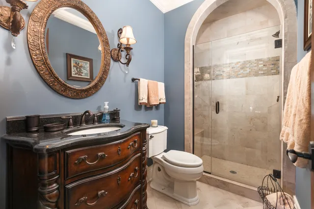 a bathroom with a sink a toilet and a mirror