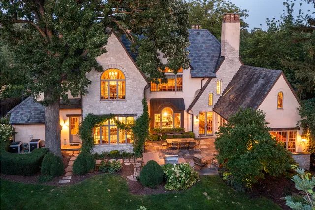 a view of house with outdoor seating space and garden