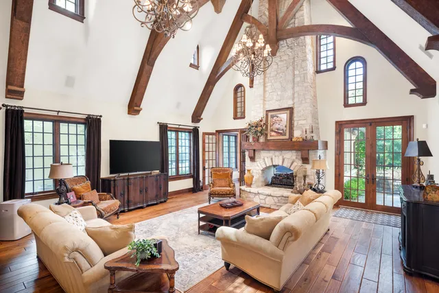 a living room with furniture a flat screen tv and a large window